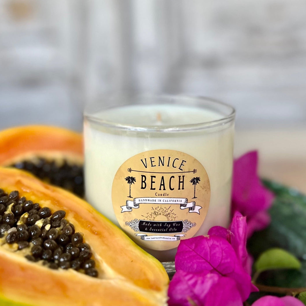 Clear glass candle with tan and black Venice Beach label