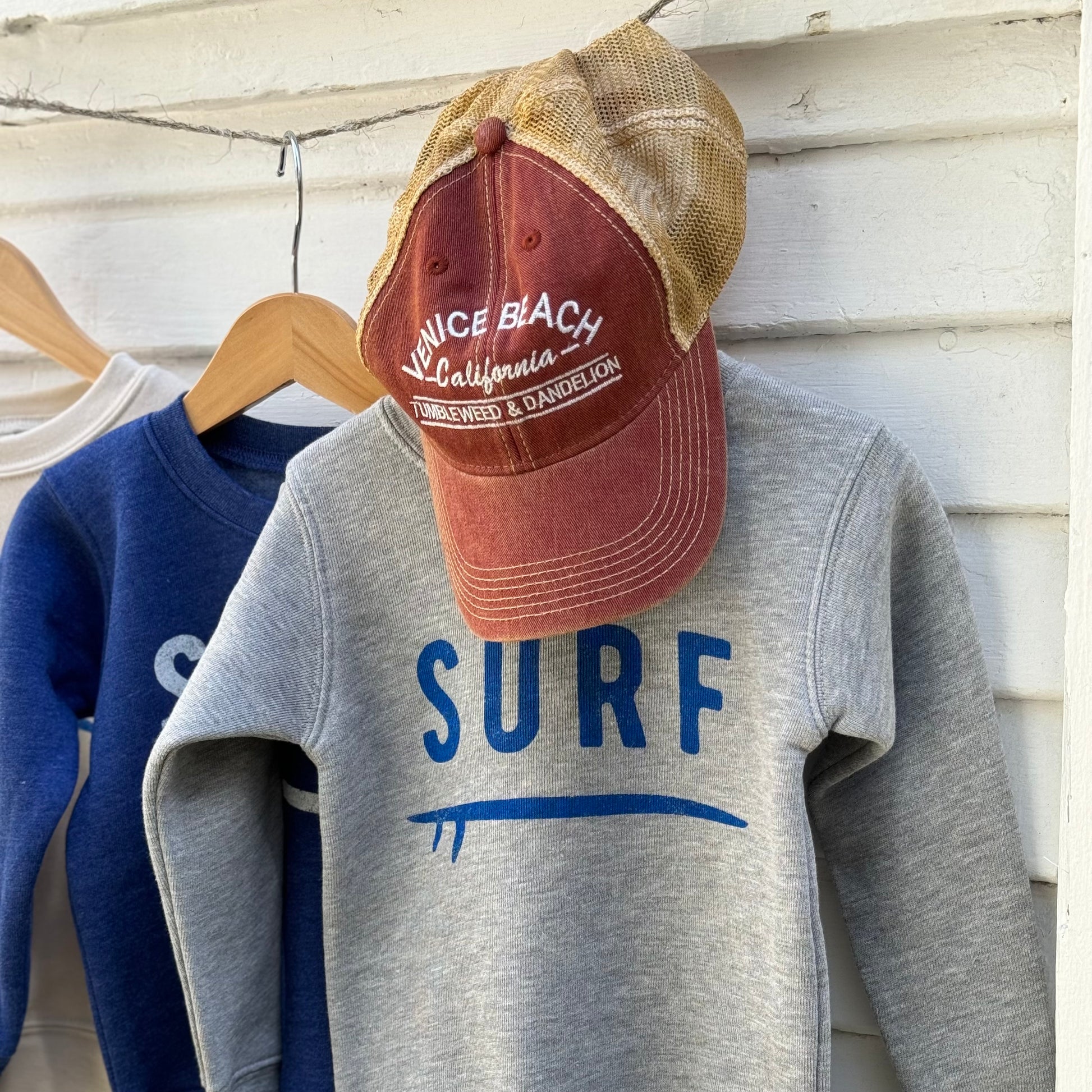 red youth cap with tan back mesh and Venice Beach California Tumbleweed & Dandelion embroidered on front