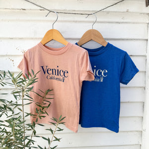pink youth tee shirt with Venice California on front in blue and blue youth tee shirt with same words in white
