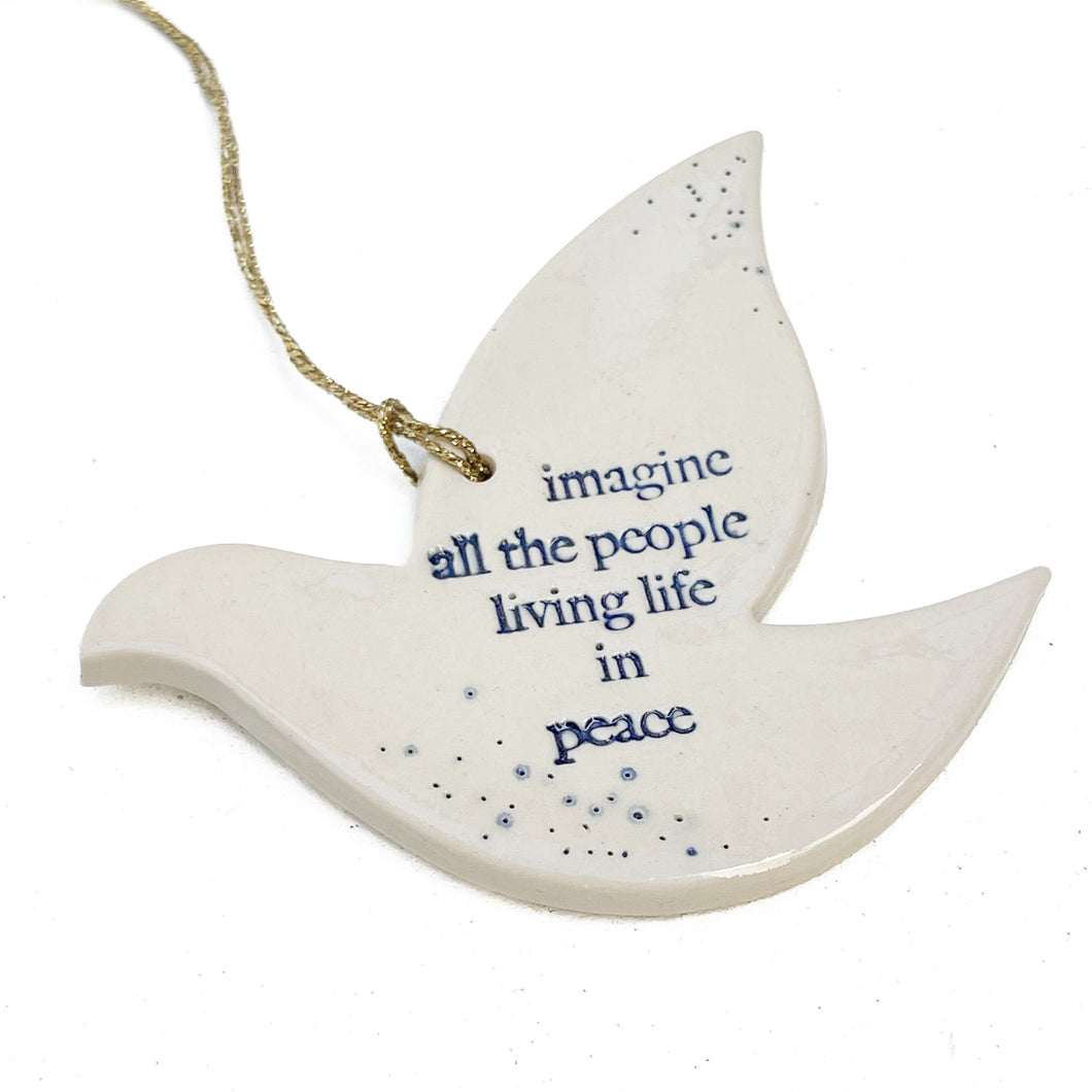 white ceramic dove ornament with words 