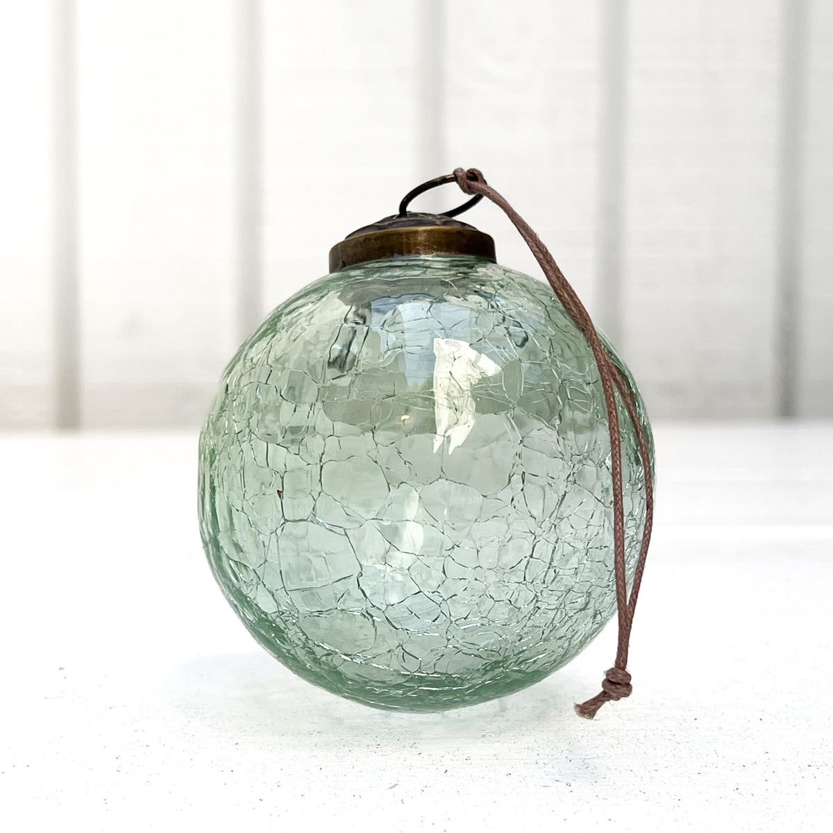 green crackle glass ornament ball with aged brass top