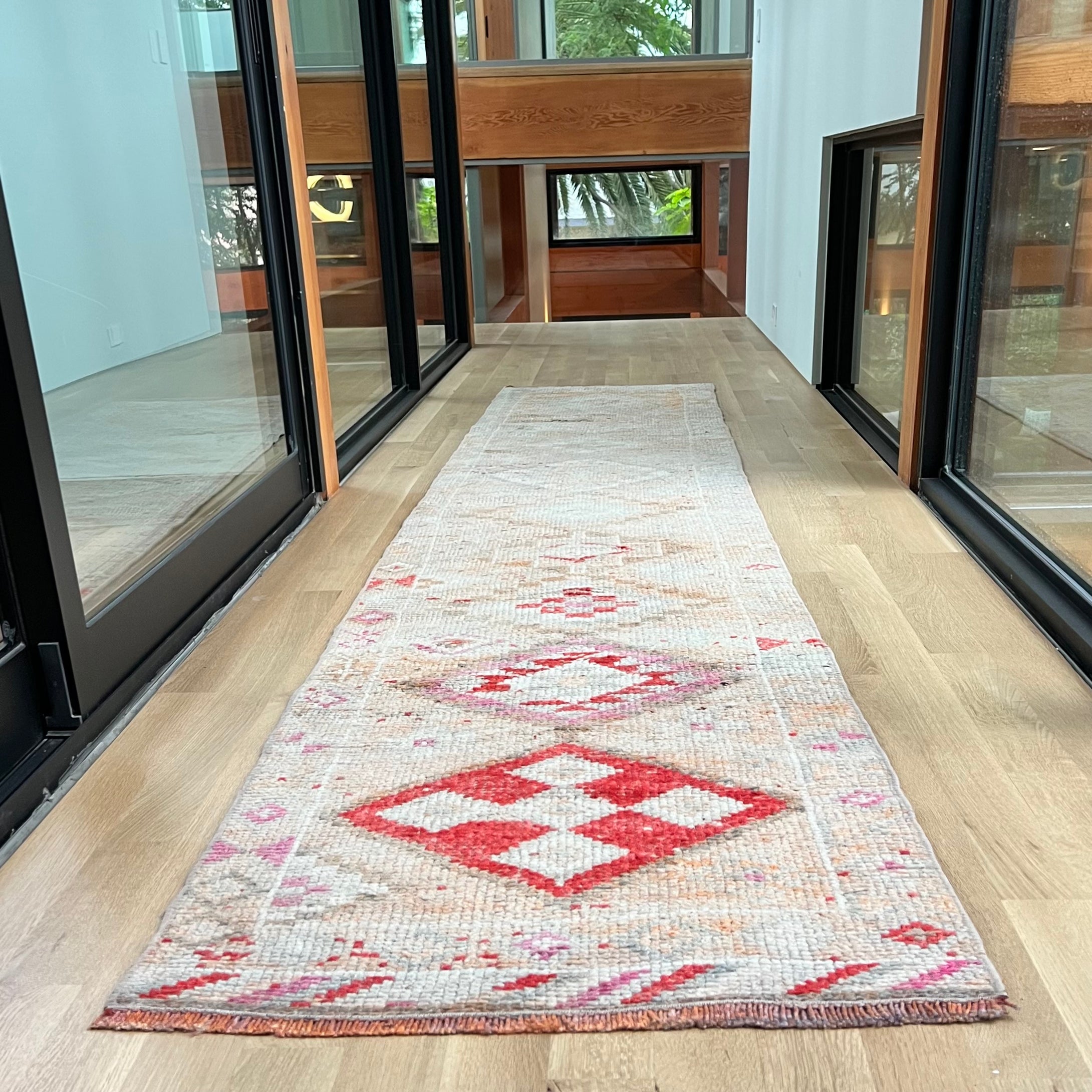 vintage Turkish runner rug with red, pink, cream and off white colors