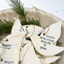 Load image into Gallery viewer, white ceramic dove ornament with words &quot;imagine all of the people living life in peace&quot; in blue
