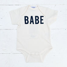 Load image into Gallery viewer, off white baby onesie with BABE in black on front