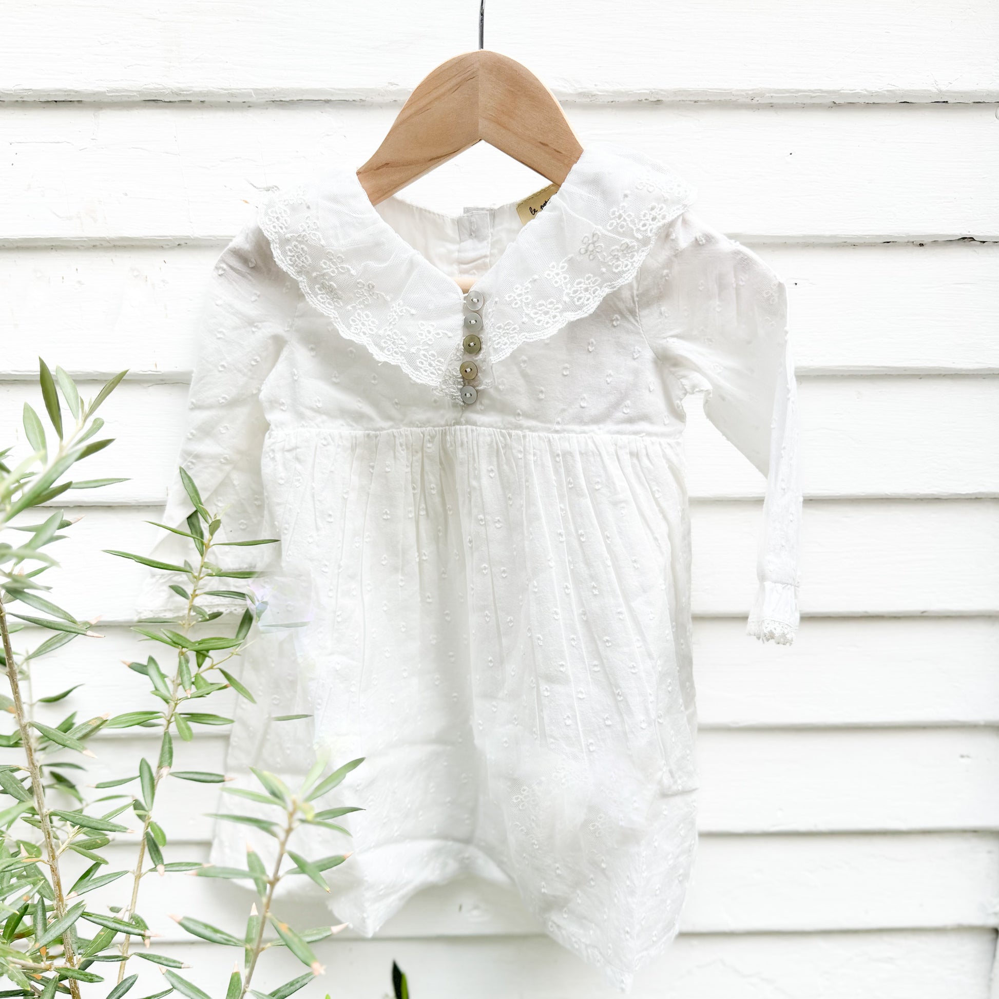 white cotton toddler dress with long sleeves and collar