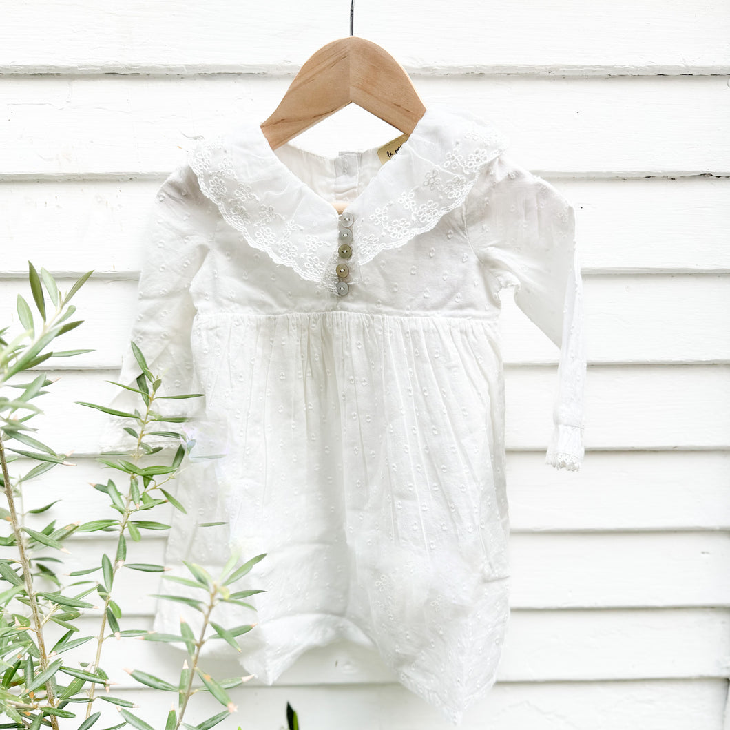 white cotton toddler dress with long sleeves and collar