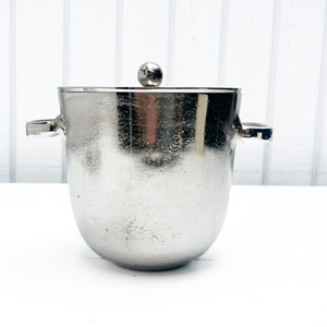 silver metal ice bucket with two handles and a lid