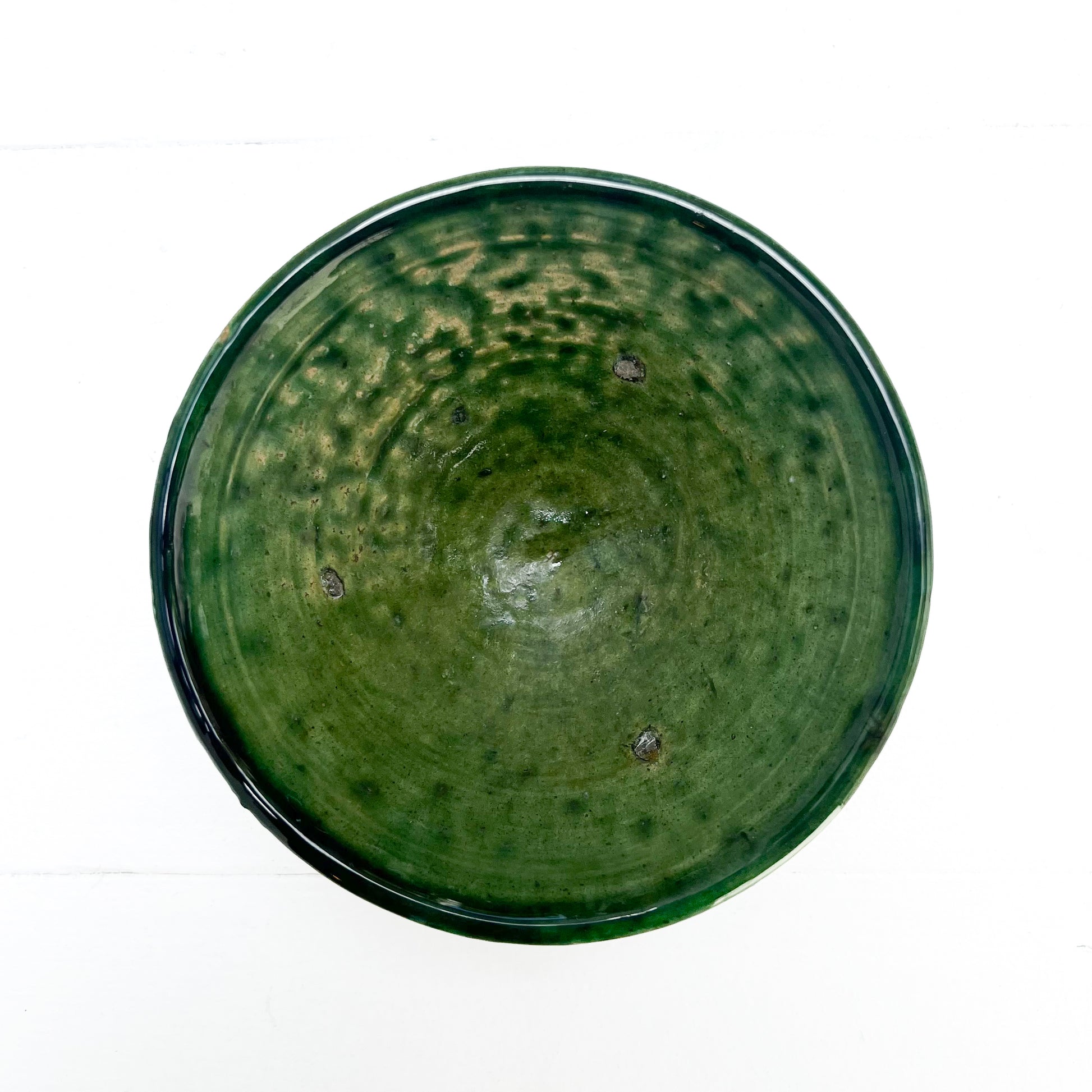 rustic ceramic handmade bowl in varying shapes and sizes with green glaze