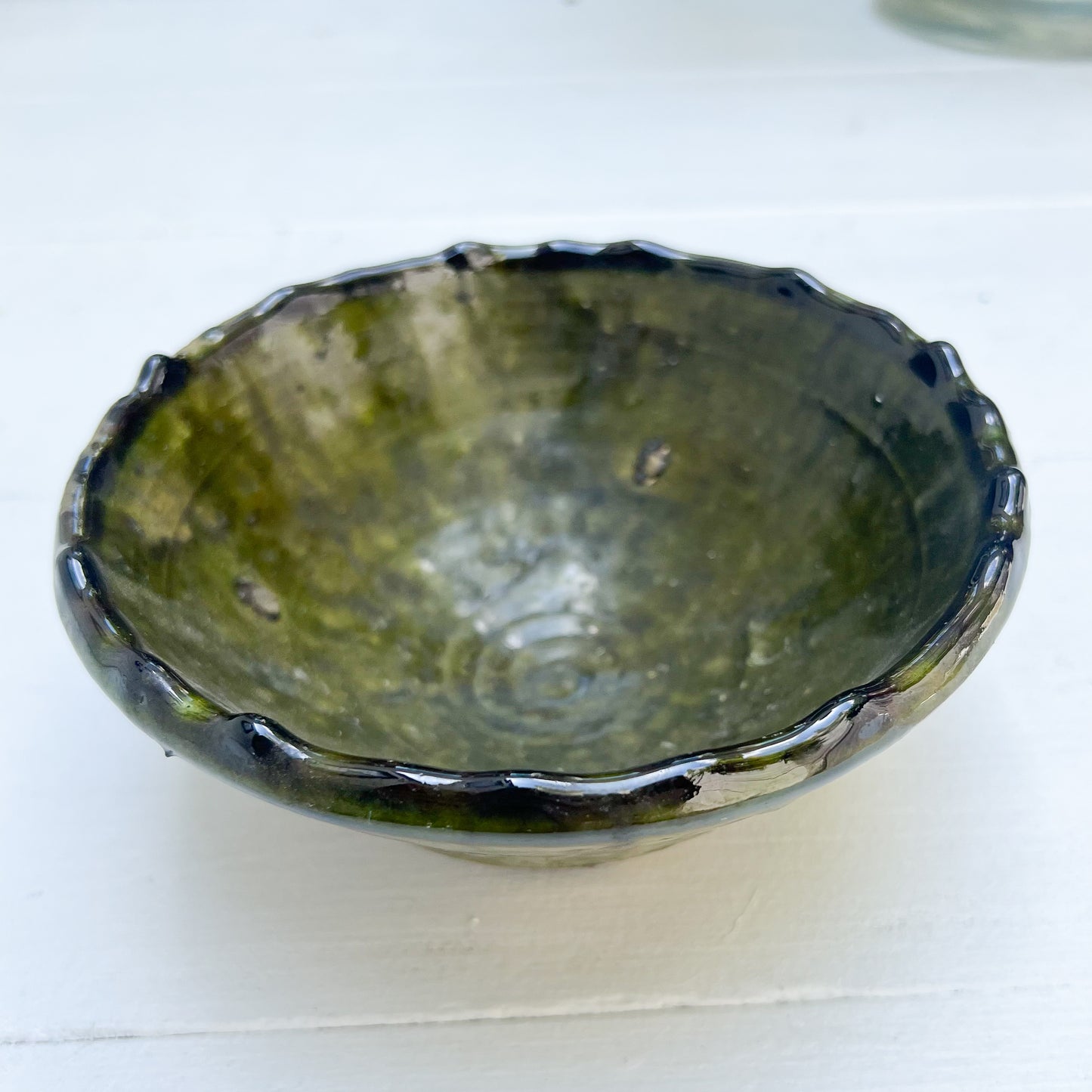 rustic ceramic handmade bowl in varying shapes and sizes with green glaze
