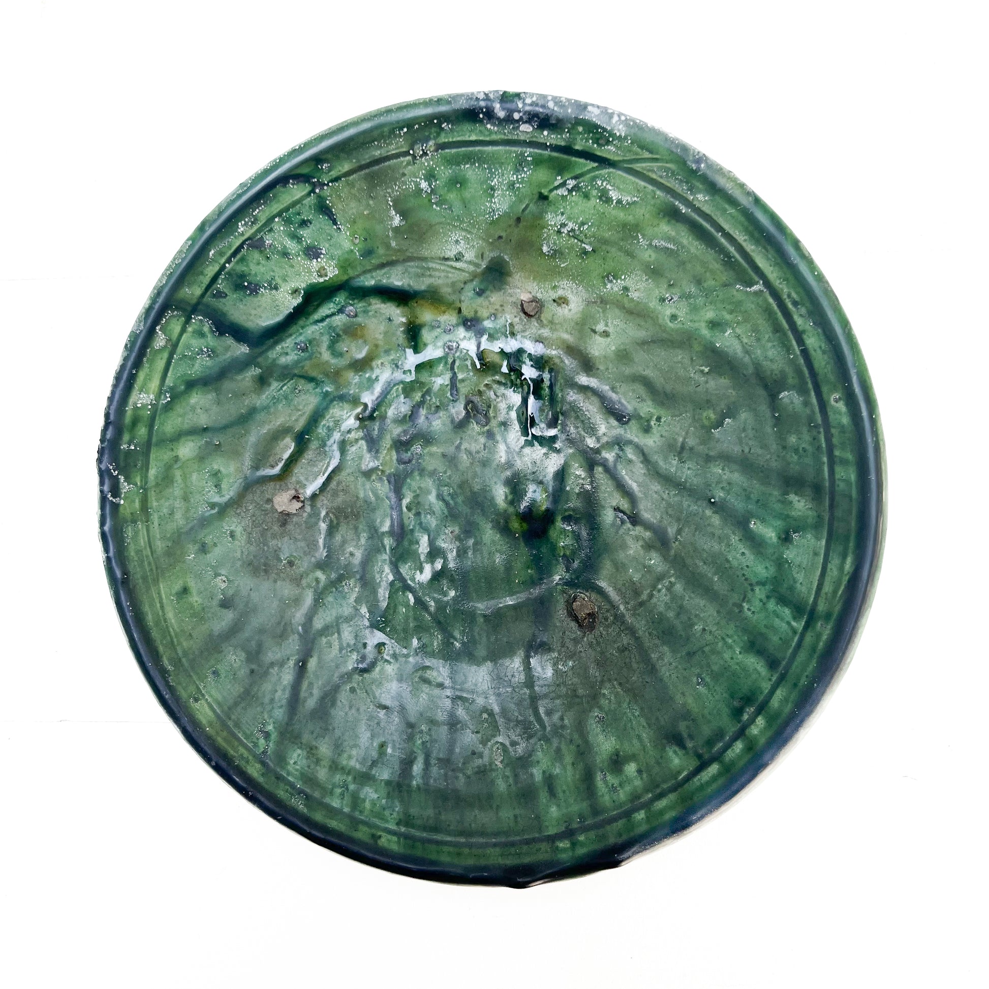 rustic ceramic handmade bowl in varying shapes and sizes with green glaze