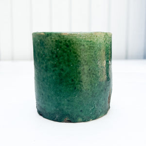 handmade rustic clay cylindrical mug with green glaze and no handle