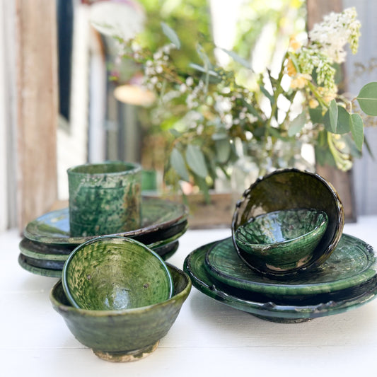 rustic ceramic handmade bowl in varying shapes and sizes with green glaze