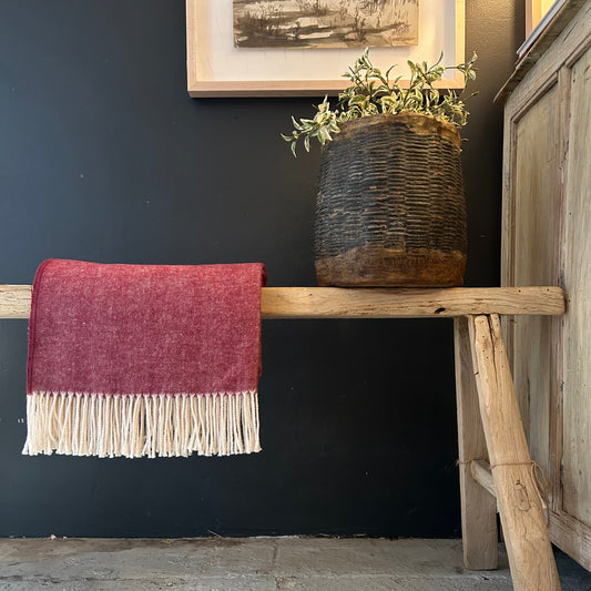 cranberry colored herringbone throw with cream colored fringe