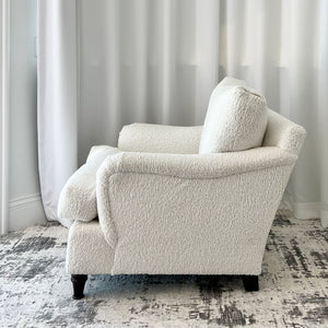 white upholstered lounge chairs with black wood feet
