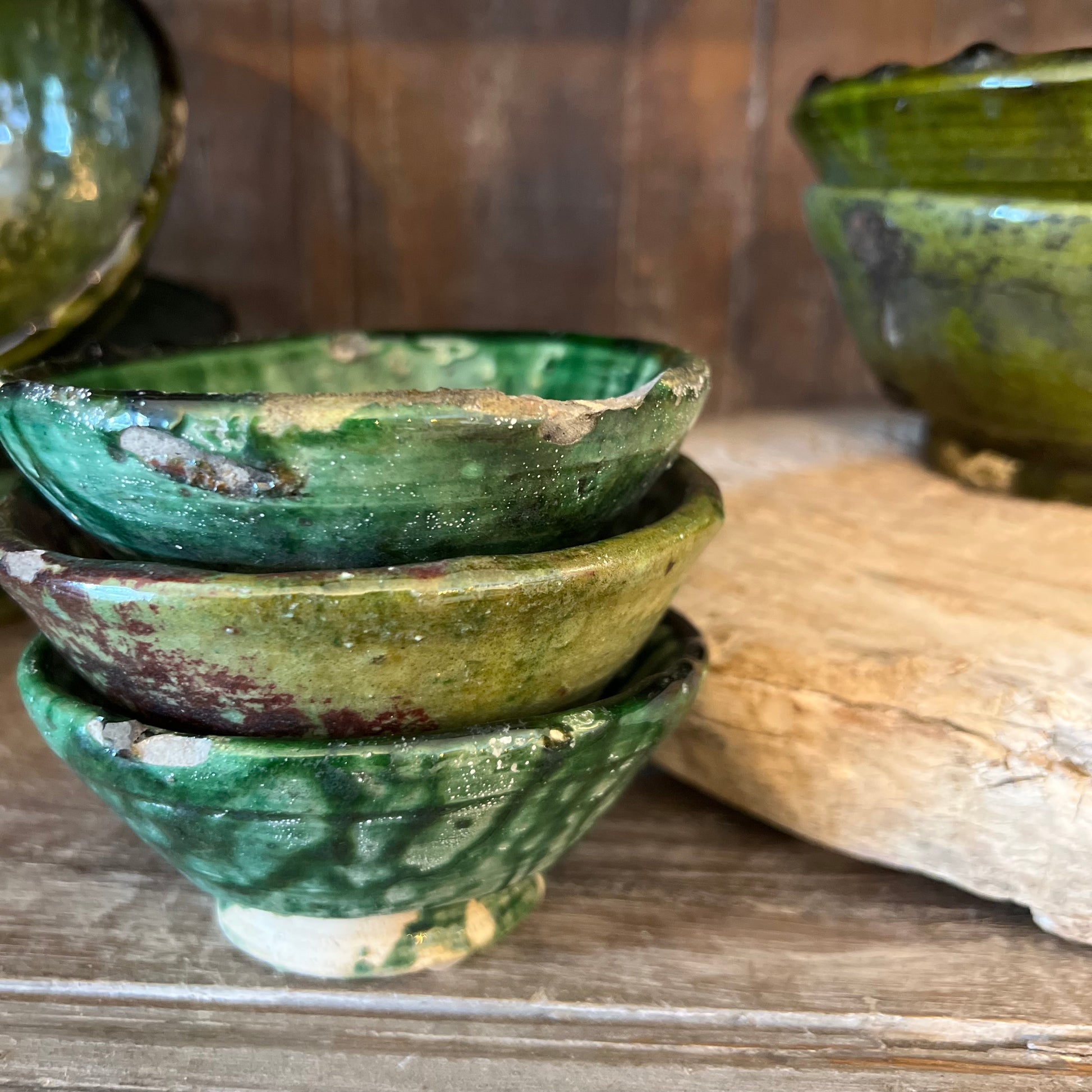 rustic ceramic handmade bowl in varying shapes and sizes with green glaze