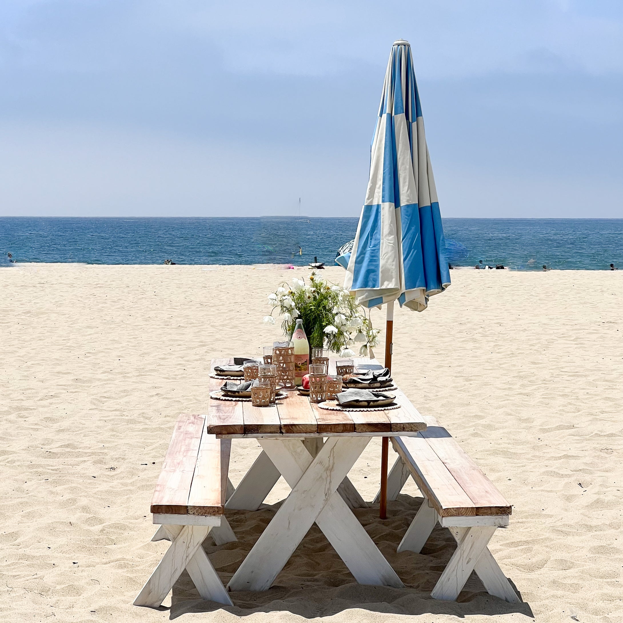 redwood outdoor picnic table and benches, natural top and white distressed bottoms