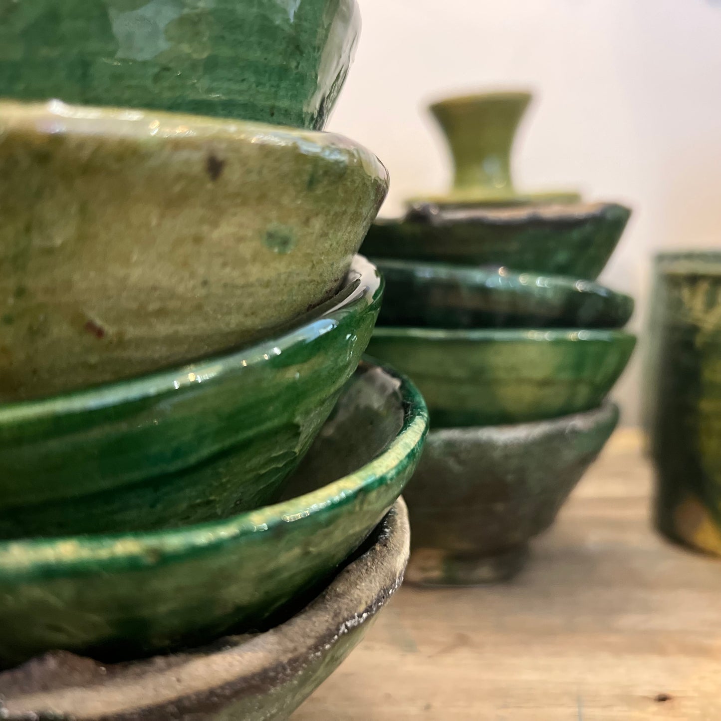 rustic ceramic handmade bowl in varying shapes and sizes with green glaze