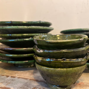 rustic ceramic handmade bowl in varying shapes and sizes with green glaze