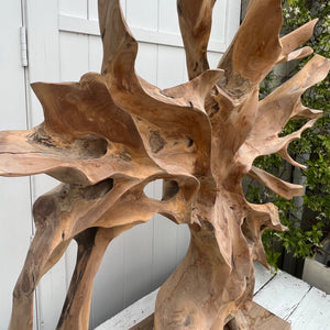 large abstract carved wooden sculpture, somewhat of a resemblance to a bare tree, black base
