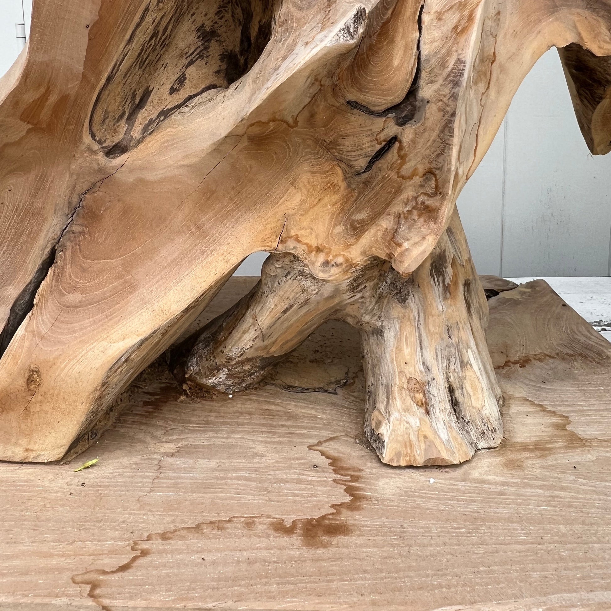 large abstract carved wooden sculpture, somewhat of a resemblance to a bare tree, black base