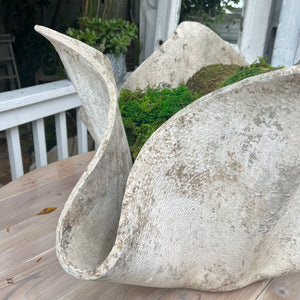 large abstract shaped concrete planter with aging 