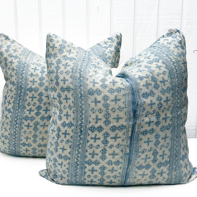 white pillow with sky blue abstract pattern