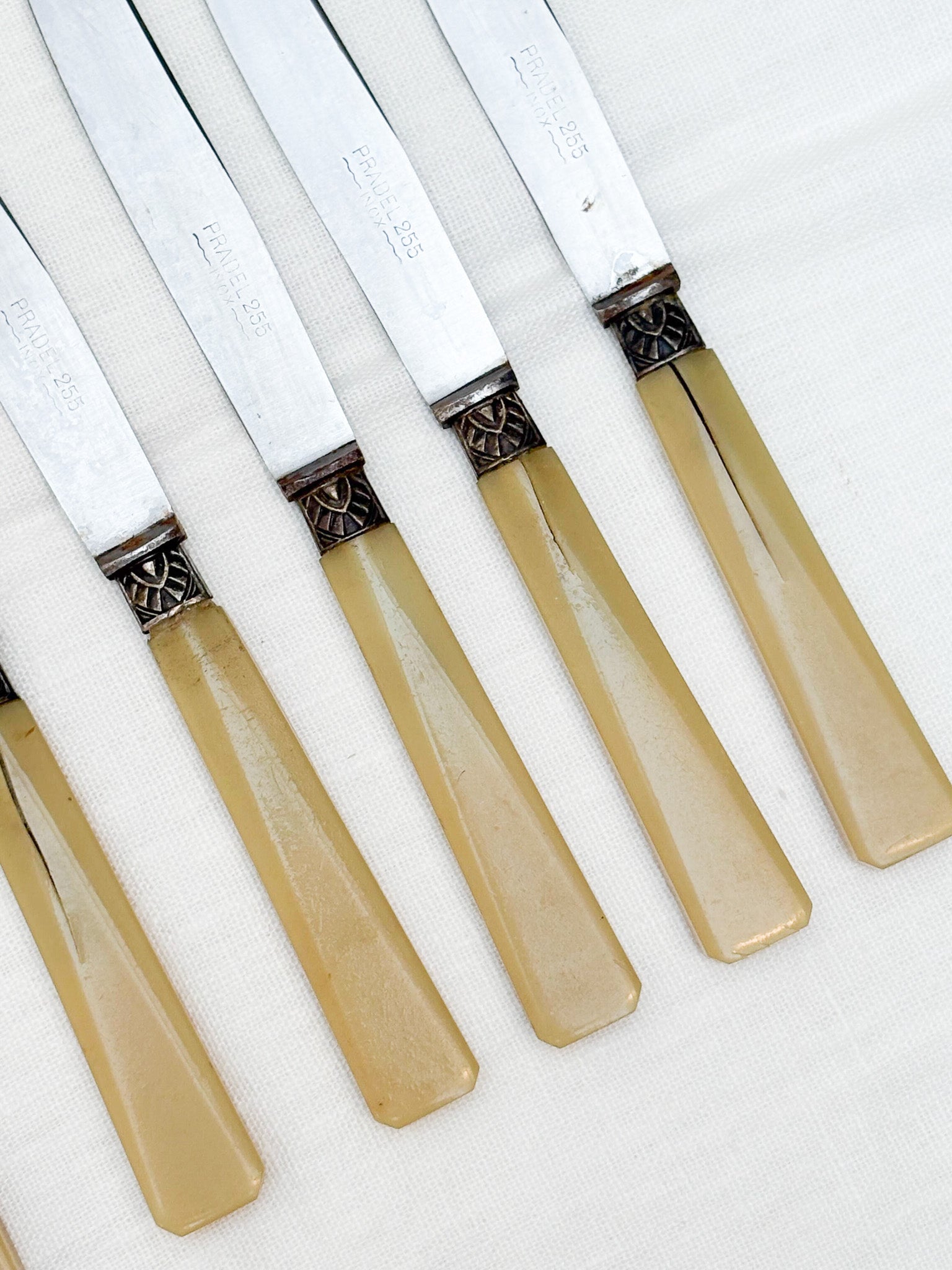 Set of knives with beige handles on a white background