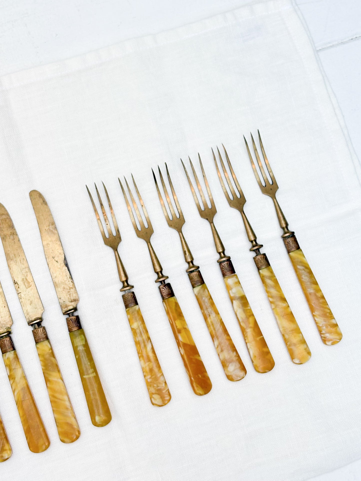 Set of vintage forks with yellow handles on a white surface