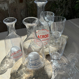 clear glass carafes with domed bottoms that have red and blue French text