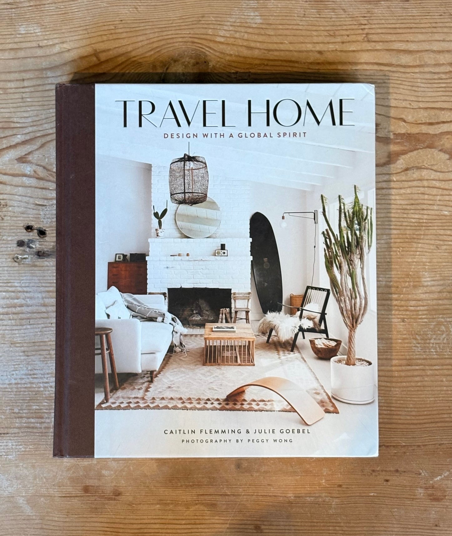 Book titled 'Travel Home' on a wooden surface