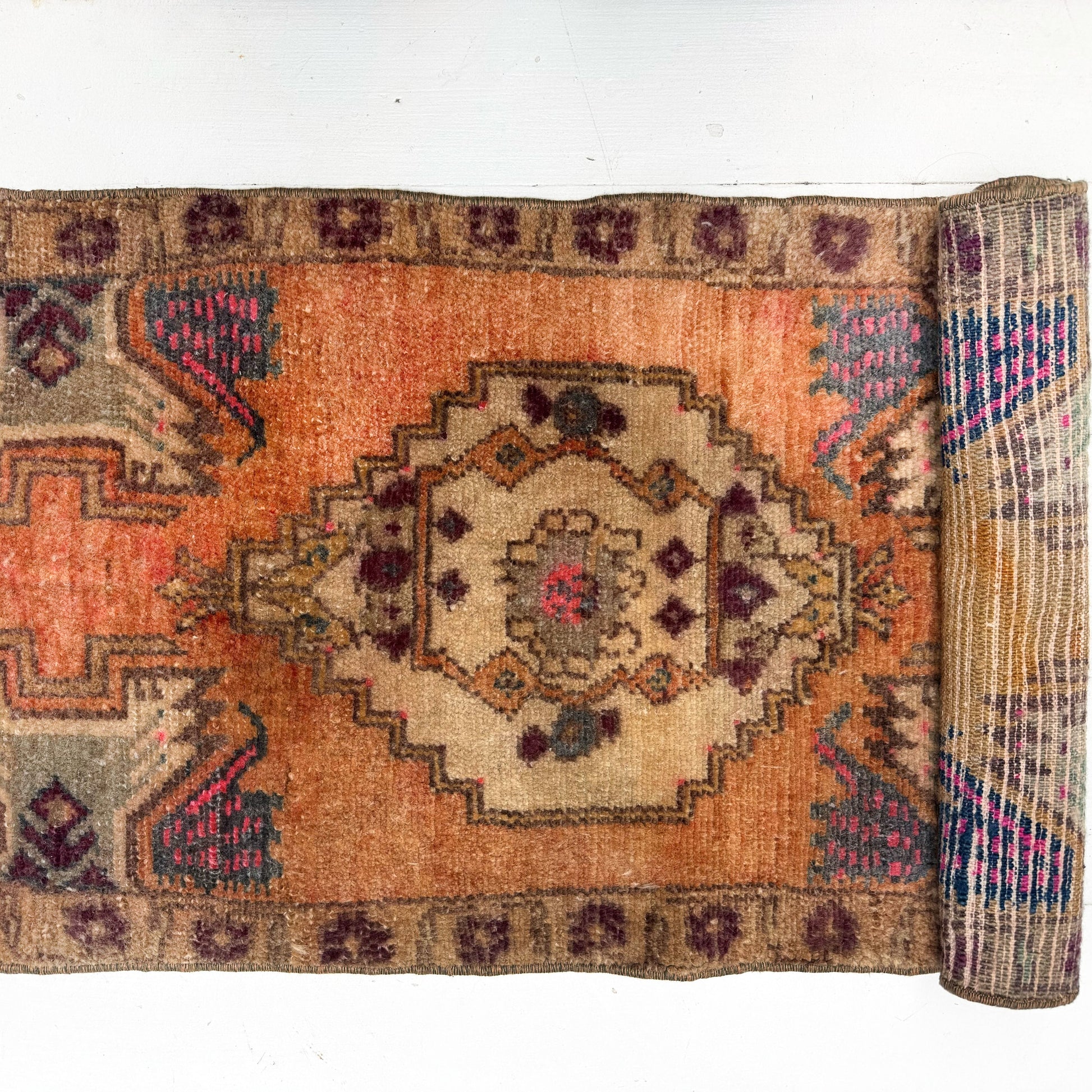 Roll-up rug with intricate patterns on a white background