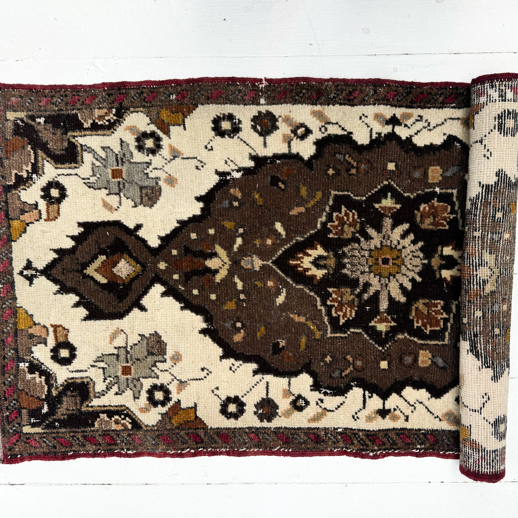 Decorative rug with intricate patterns on a white background