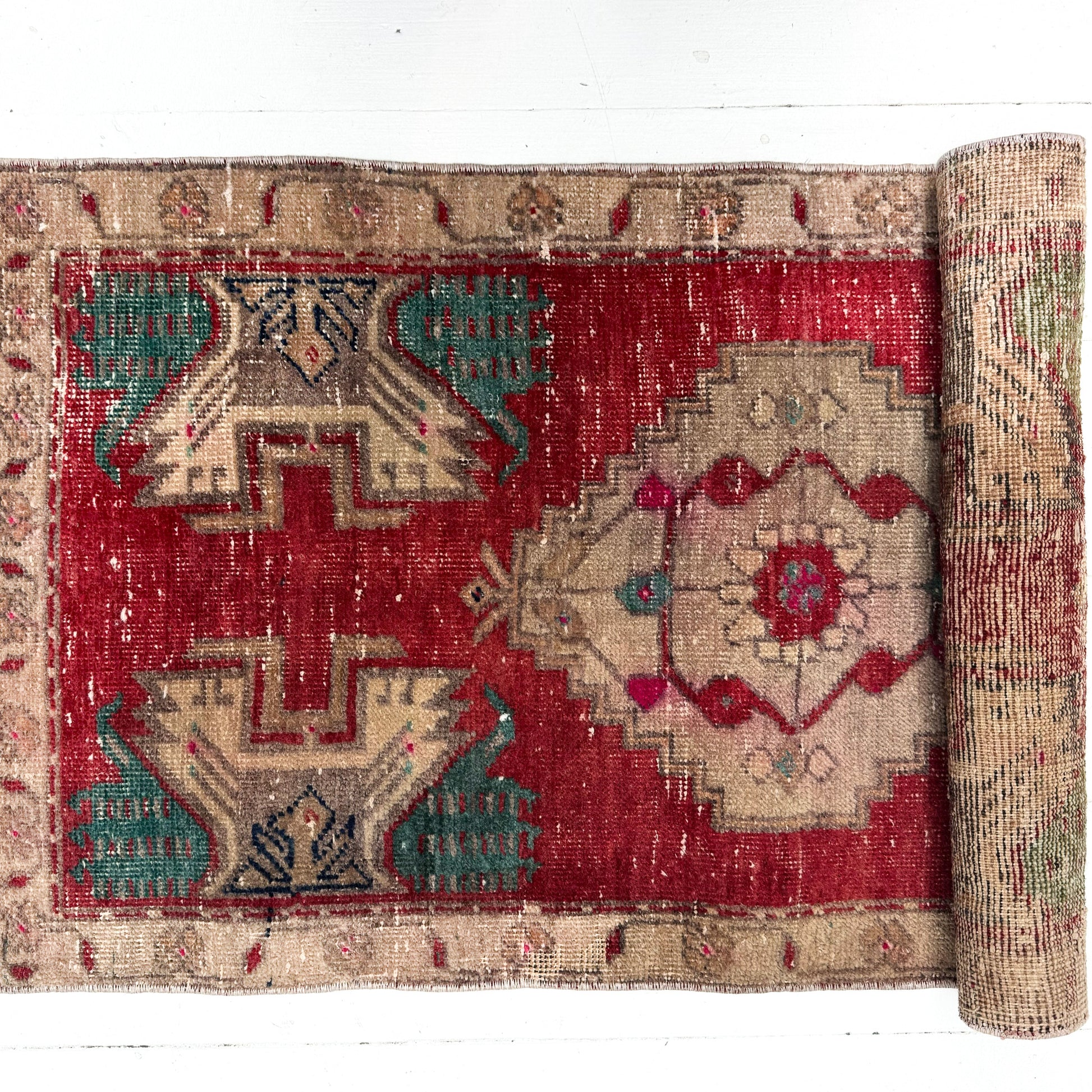 Roll-up rug with intricate patterns on a white background