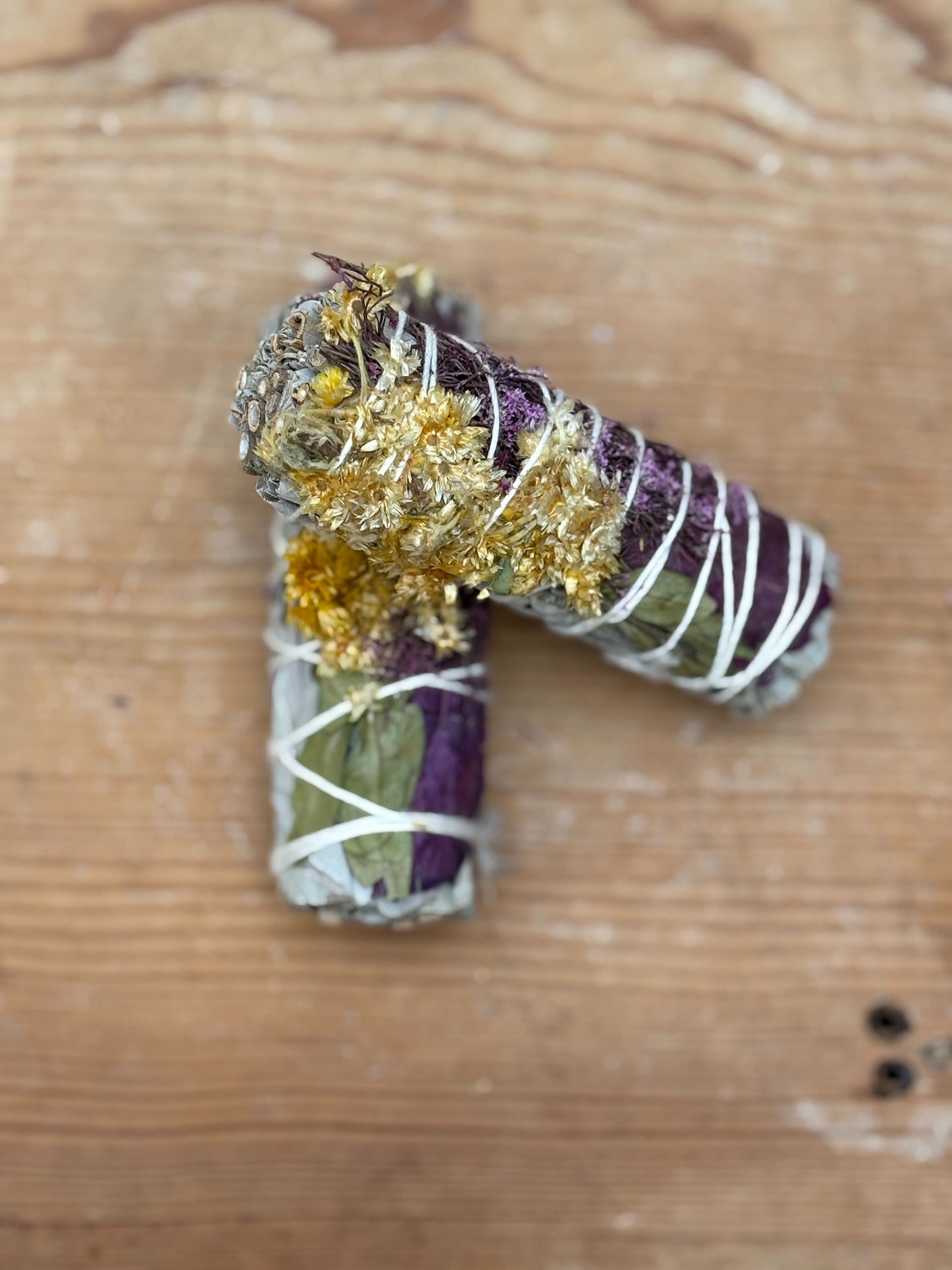 Decorative letter 'P' with gold and purple elements on a wooden surface