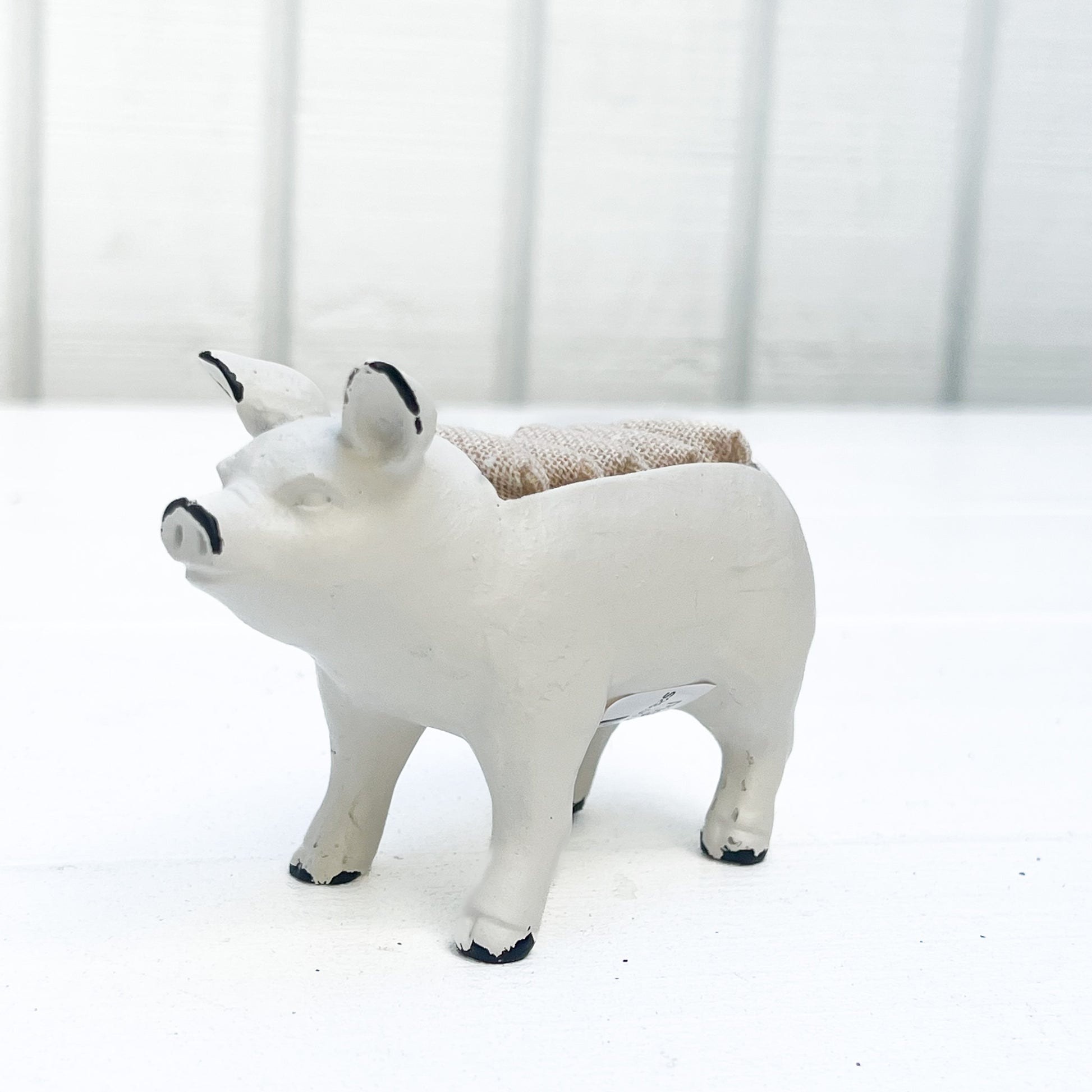 white metal pig ring holder, with burlap slots on top for rings