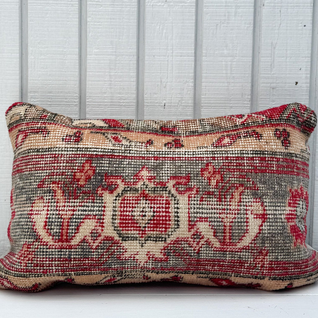 Decorative pillow with intricate patterns on a wooden surface