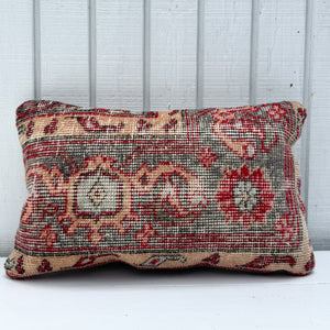 Decorative pillow with floral pattern on a wooden background