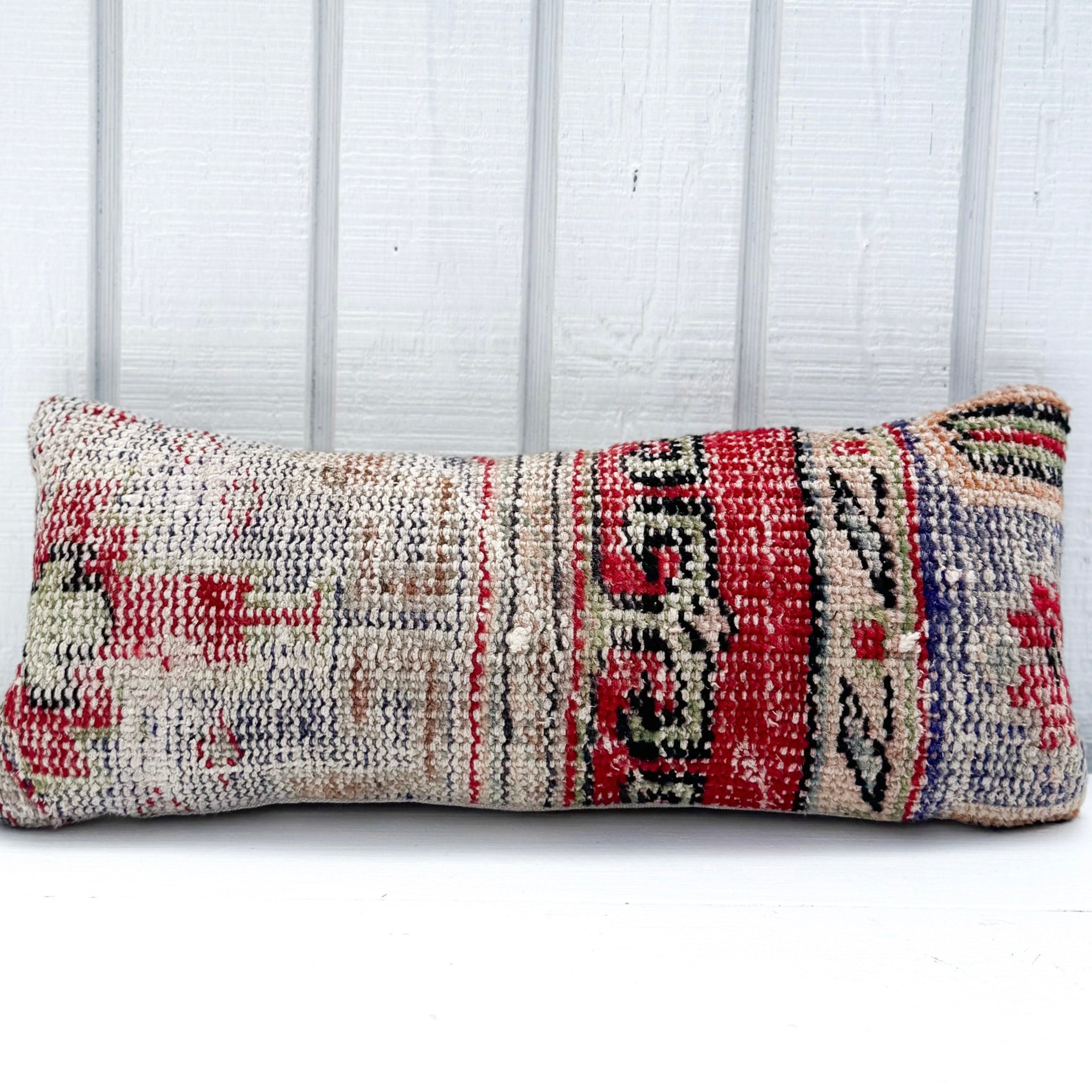 Textured pillow with geometric pattern on a white background