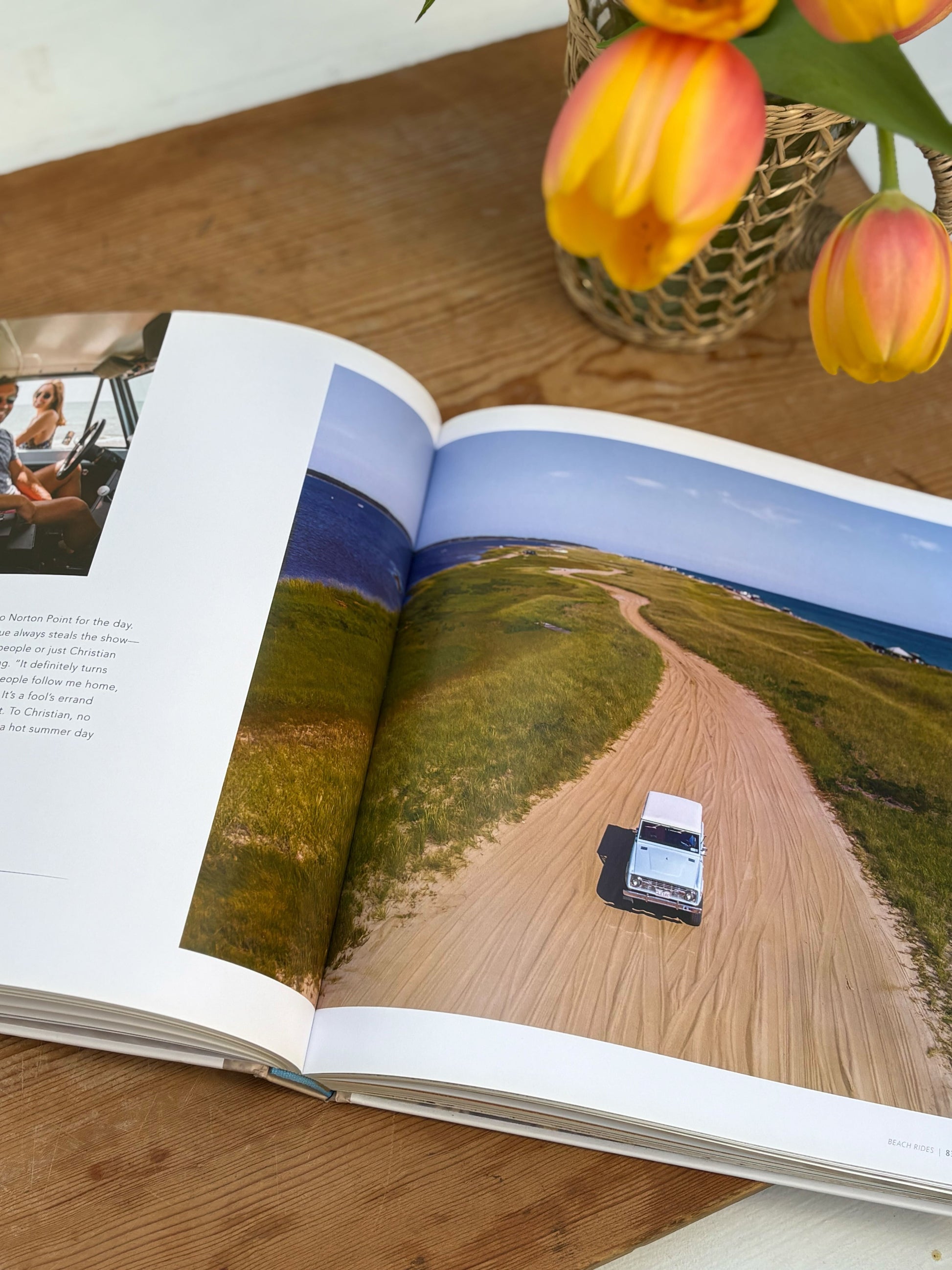 open book to a page with a jeep on a sandy coastal road