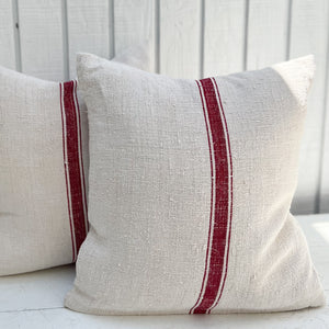 off white grain sack fabric pillow with three red stripes down the middle