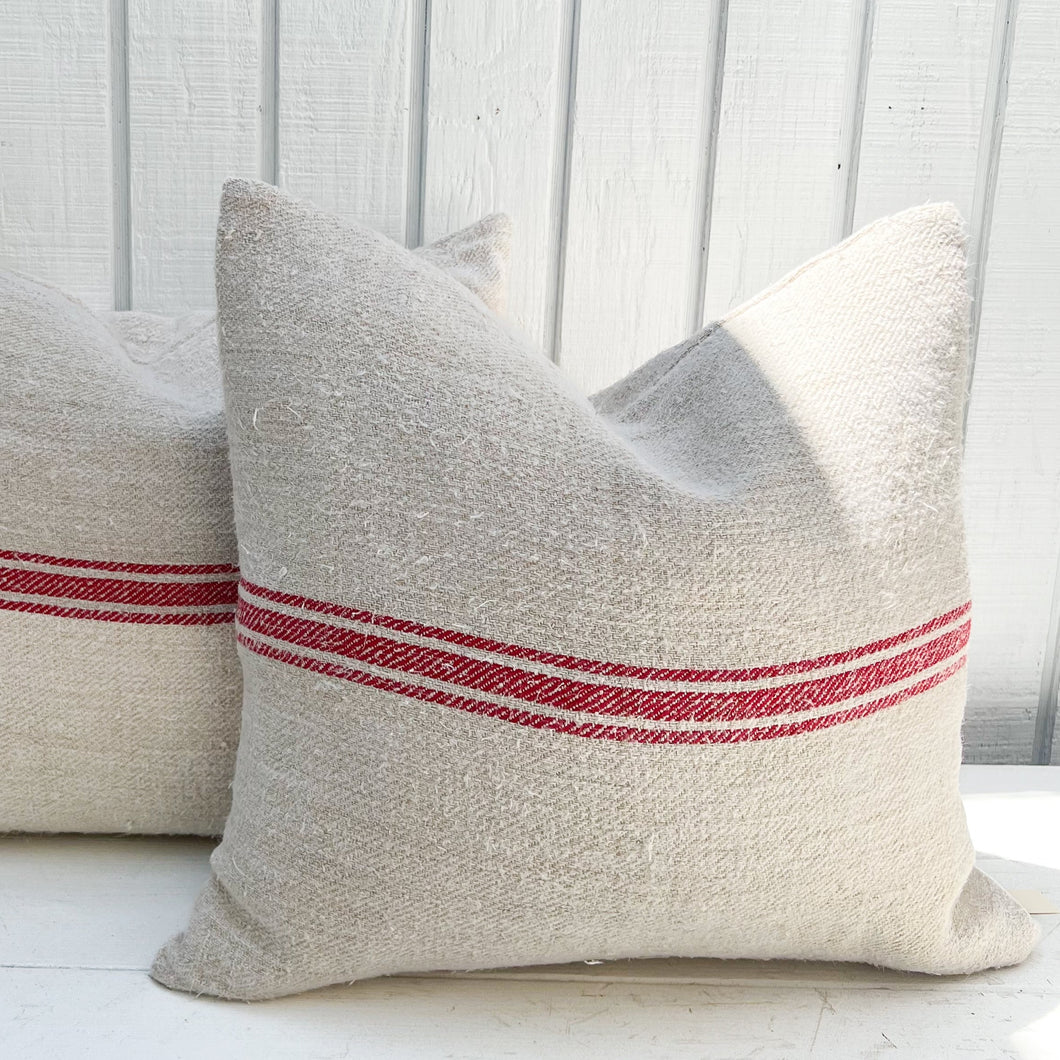 off white grain sack fabric pillow with horizontal red stripes