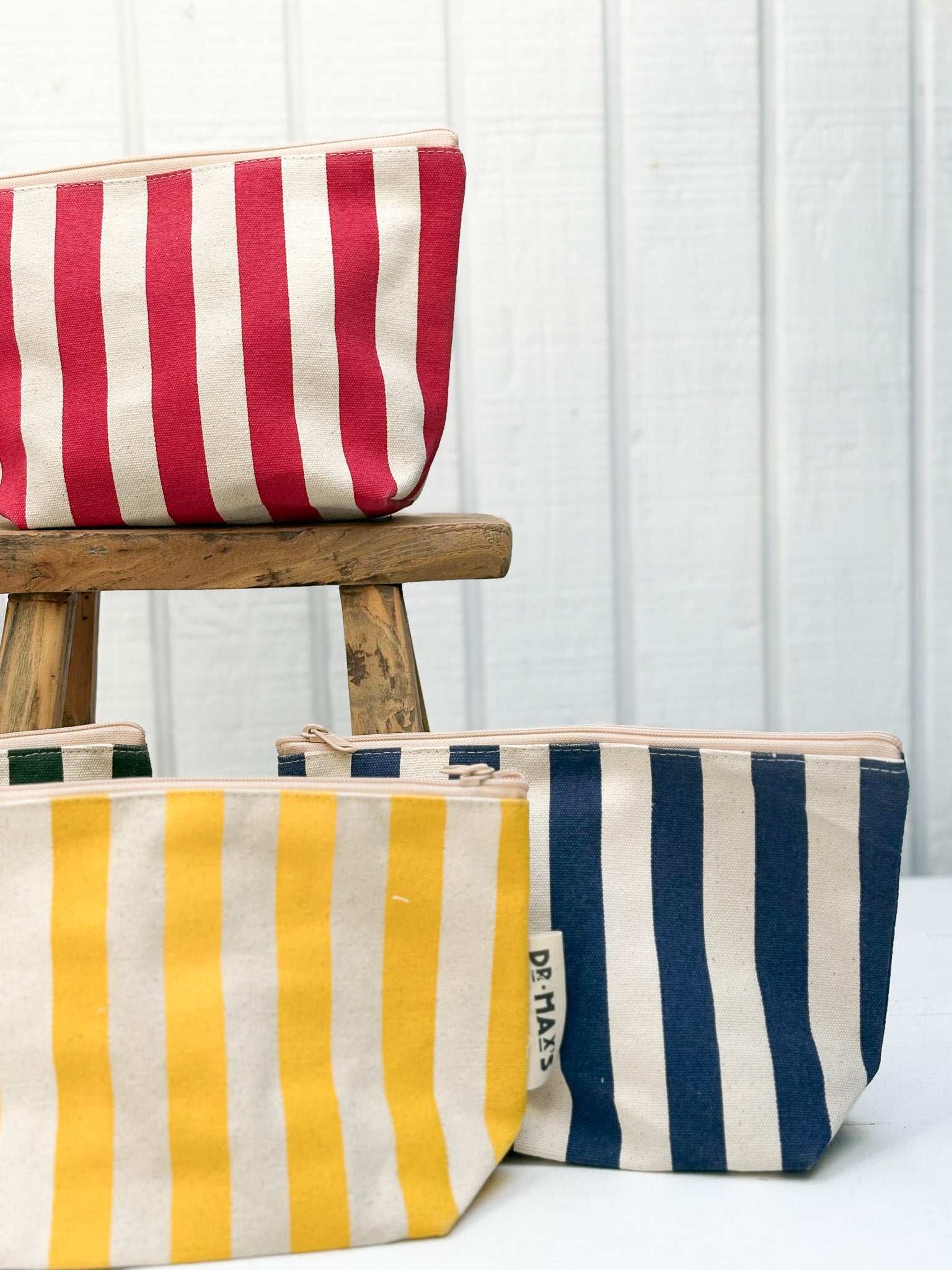 Striped pouches in red, yellow, and blue on a white background