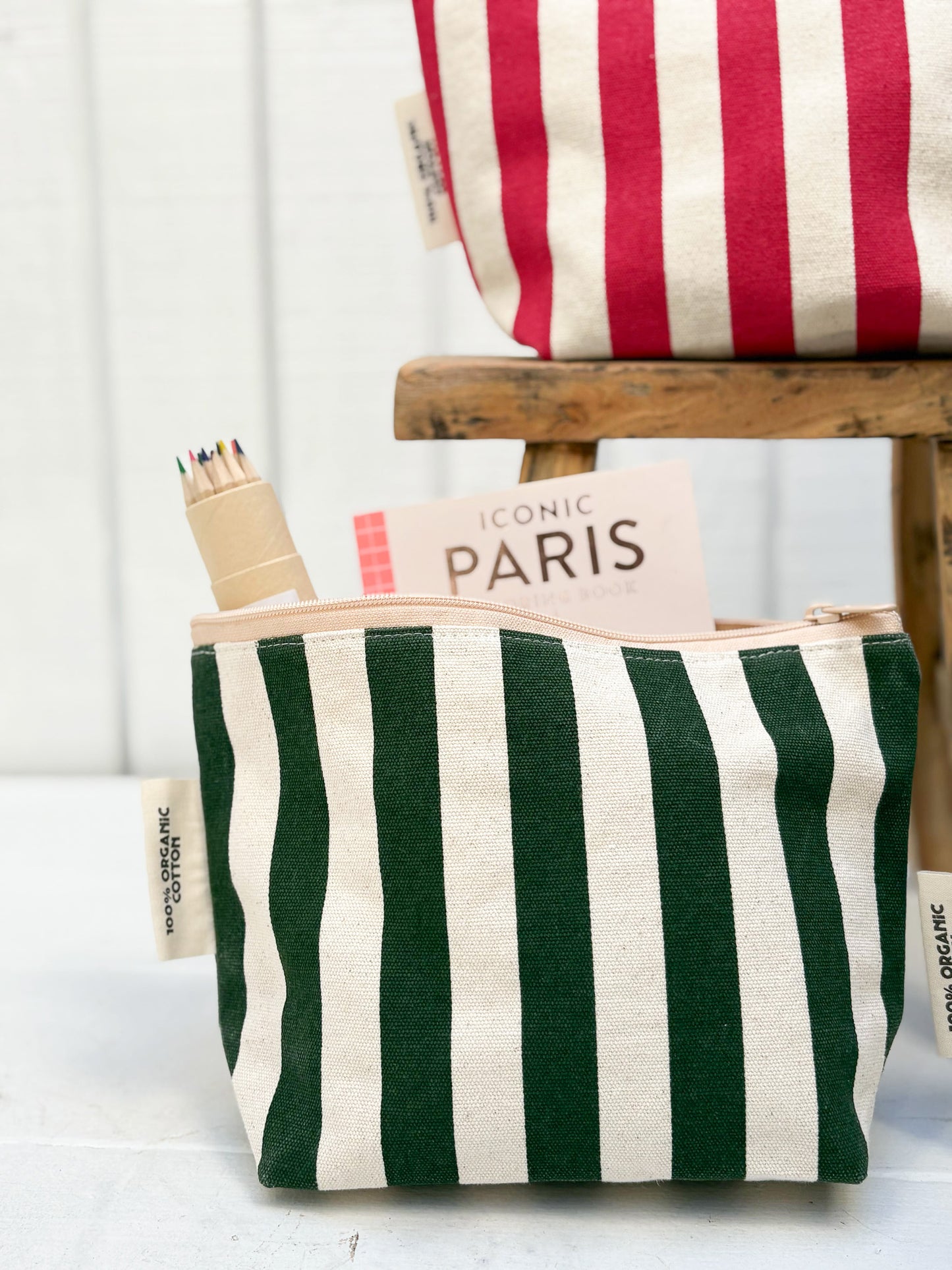 Green and white striped pouch with 'Iconic Paris' text on a white background