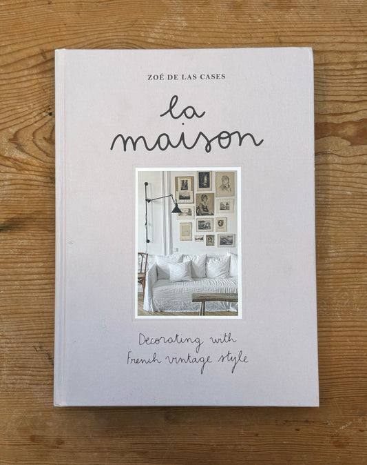 Book titled 'La Maison' by Zoé de las Cases on a wooden surface