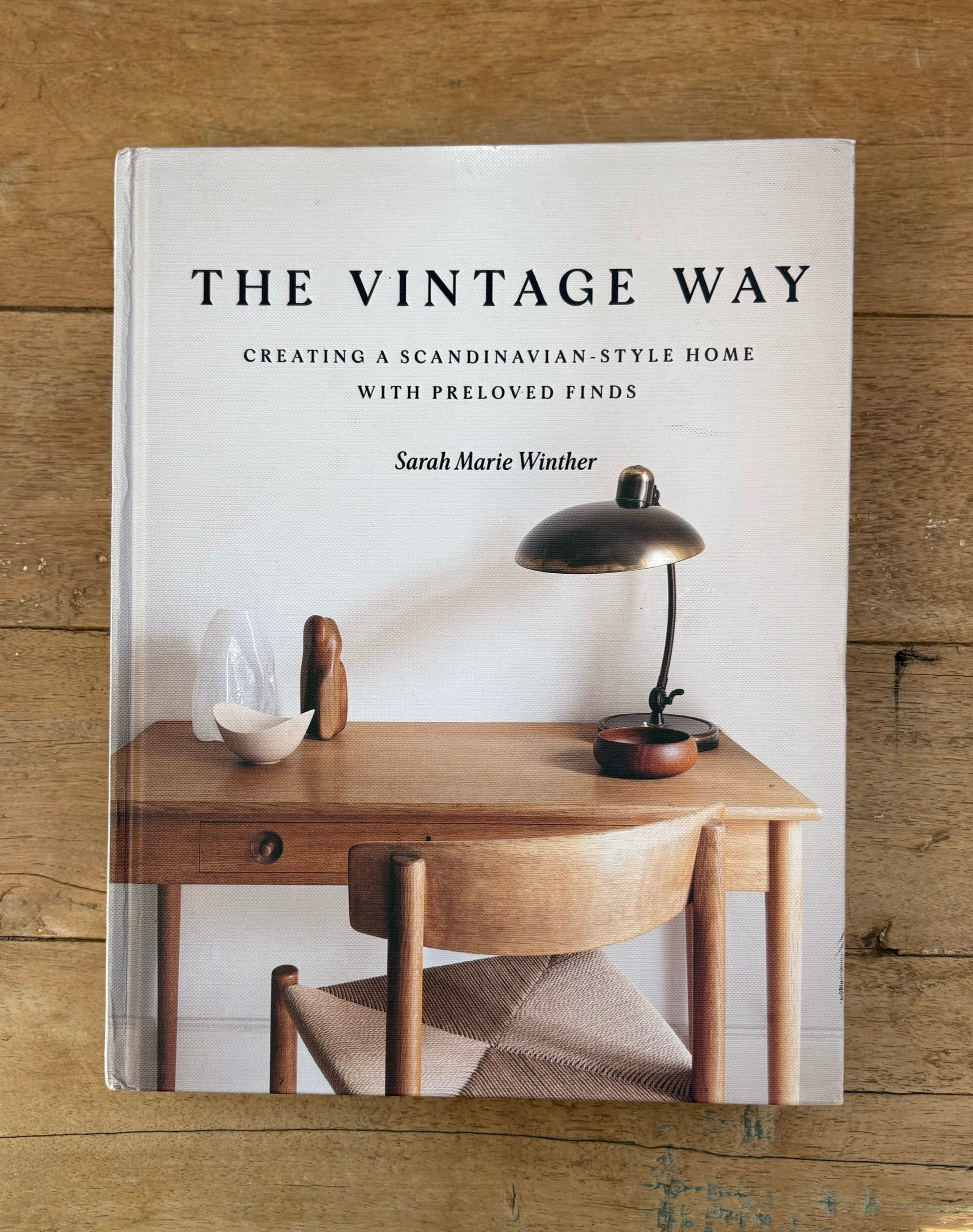 Book titled 'The Vintage Way' on a wooden surface
