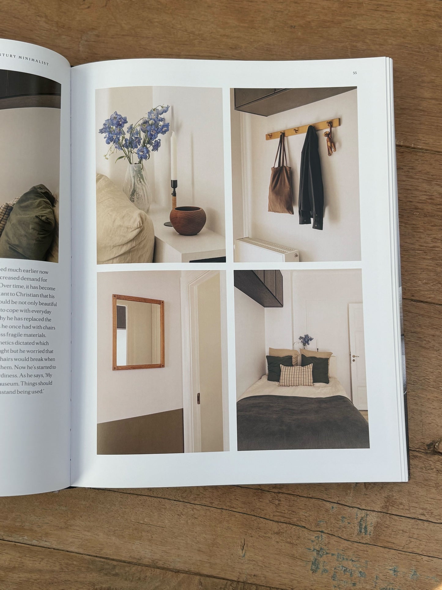Open book showing interior design images on a wooden surface
