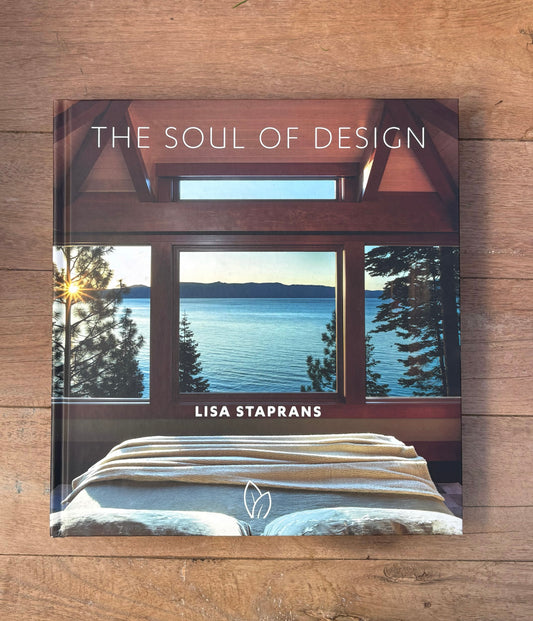 Book titled 'The Soul of Design' by Lisa Staprans on a wooden surface