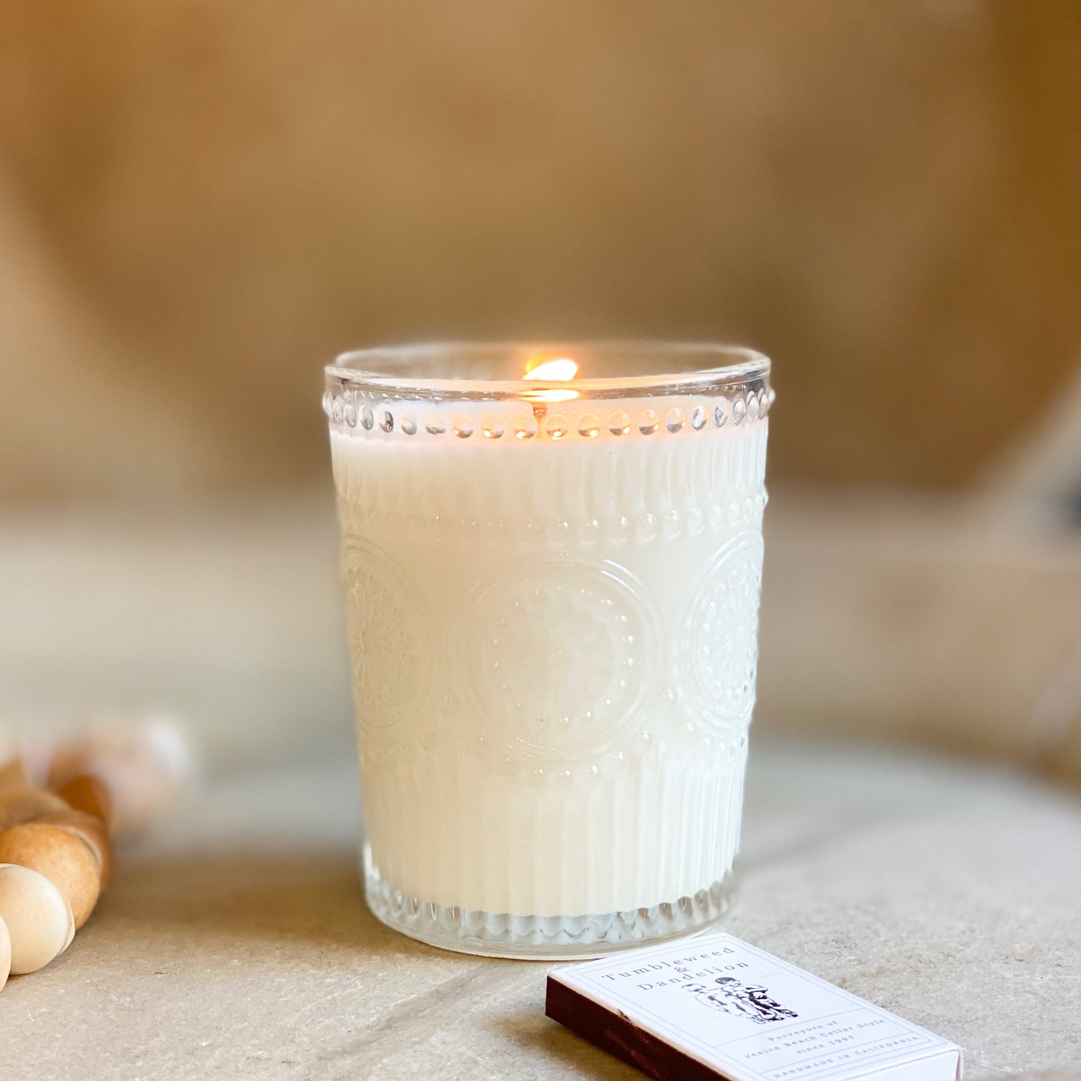 embossed clear glass jar with candle