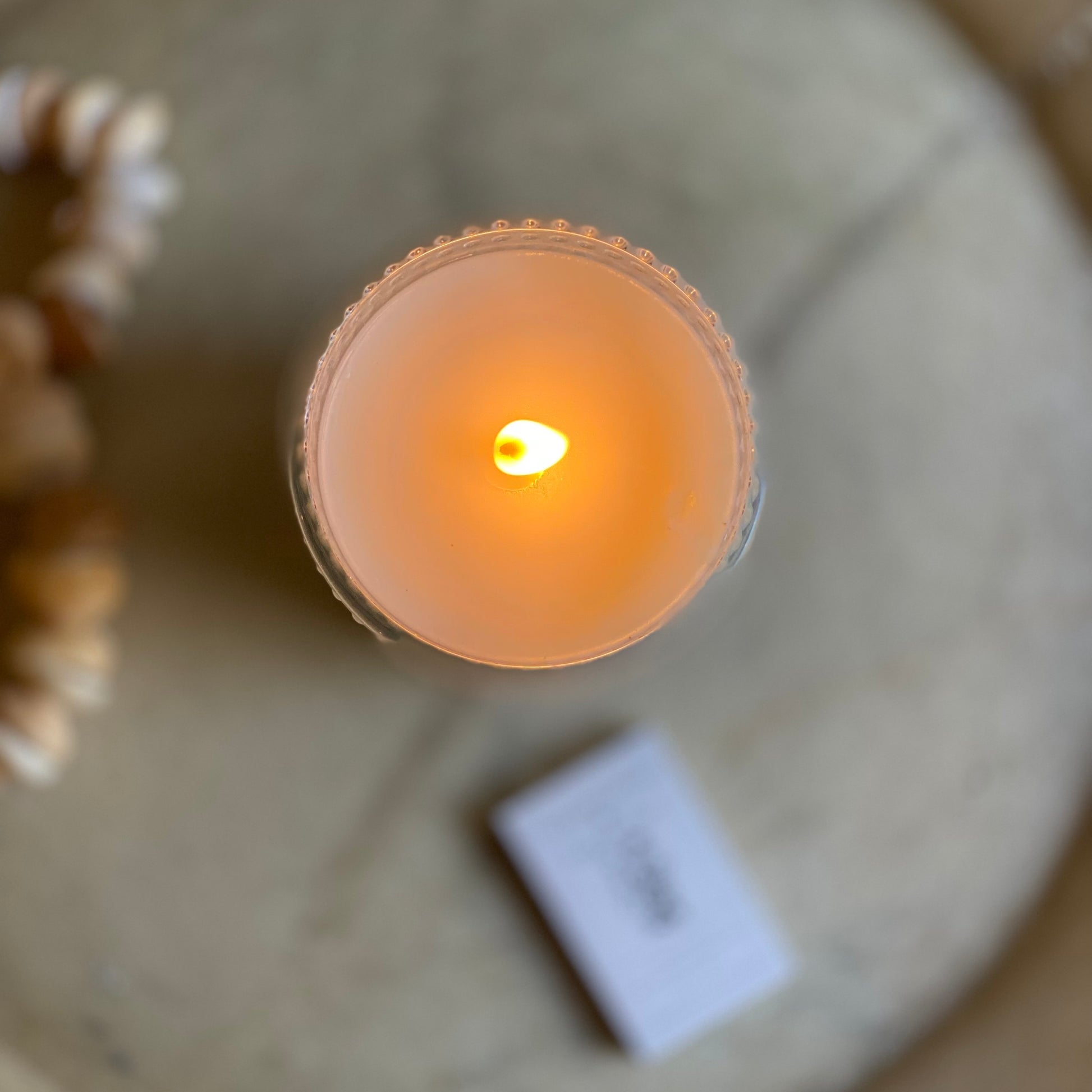 embossed clear glass jar with candle