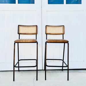 metal framed barstool with brown leather seat and cane back